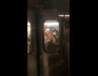 Large amounts of people rush inside subway train