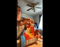 Woman carefully opens container of biscuits 