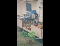 Guy grills meat in the rain 