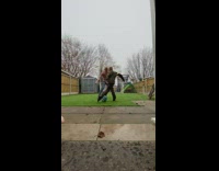 Dad plays soccer with son backyard net