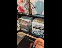 Man reacts at display magazines on counter