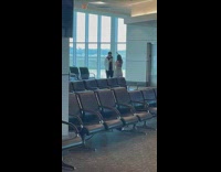 Woman in stripes crop top tiktok dance at the airport