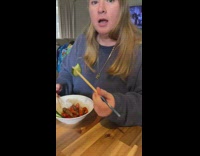 Woman pokes food with chopstick flings it