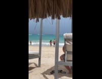 Couple hold hands towards beach for video