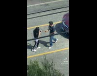 Guy black shirt front of red car