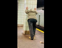 Guy stretches at train station 