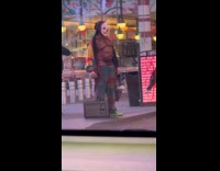 Half naked clown standing on the street