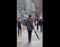 Man wearing jacket harassing people on street