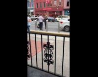 Man holds phone for woman at street