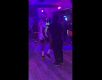 Three men dance battle on dance floor