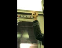 Guy leaves burn marks on subway train ceiling using a lighter