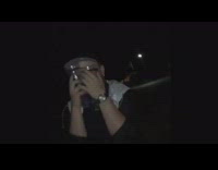 Guy black white windbreaker holding clear cups in front of face falls over