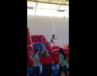 girl jumping on red inflatable balls bounces off