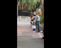 Woman black skirt tiktok dance on sidewalk