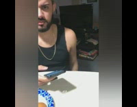 Guy with blonde hair on phone gets slapped in the face with slice of cheese