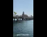 Guy backflip wood bridge railing lands back