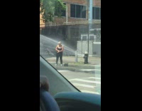 Girl stands by broken fire hydrant water
