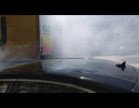 Tropicana pick up truck drives down street and leaves trail of smoke