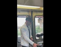 A man has a squirrel on a leash on his shoulder