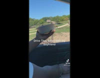 Guy feeding animals in car of drive thru safari 