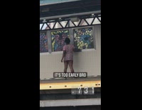 Lady standing on train platform twerks 