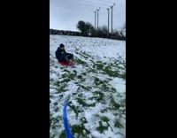 Guy sleds with small sled onto bump 