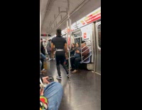 Man acrobatics dance in subway train handrails