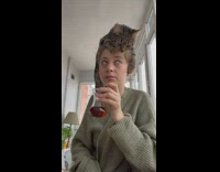 Woman eat breakfast while cat on her head