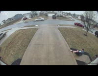 Man takes out trash slips on driveway