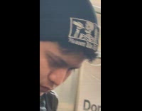 Man wears skeleton black bonnet in subway