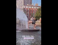 Guy does backbend middle of water fountain 