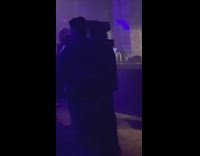 Man dance with television mask at bar 