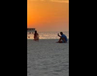 Woman red bikini kneel pose at beach