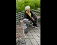 Collab WINY - Lady on Bench Feeds Pigeons at Park