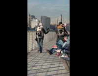 Woman carries chubby cat on her back