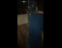 Guy jeans black shrit tries to jump spin kick punching bag misses