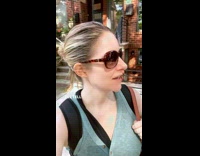 Woman on sidewalk talks about pigeon story