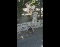 Woman tank top bend over street graffiti