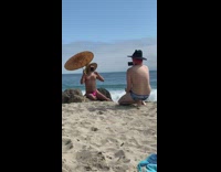 Black face mask pink speedo guy beach 