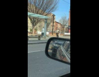 Man Happily Walks and Sings on Street Pavement