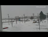 Small loader pushes big rig out of snow