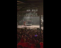 Man vacuuming the stage during intermission at concert