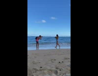 Woman walks by camera holding coconut drink