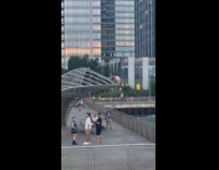 Men climbs sculpture at pier 
