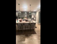 Man lays down on kitchen counter hiding from dog 