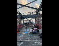 People cheer for biker passing by 