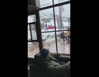 Woman purple pink outfit poses for picture in snow