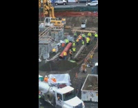 Construction workers stretch before shift site window