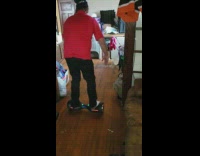 Dad red shirt loses balance on hoverboard and falls hard on the ground