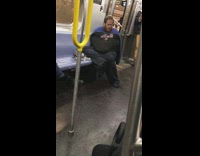 Guy in Mets puts arms in shirt sleeve and masturbates on subway train